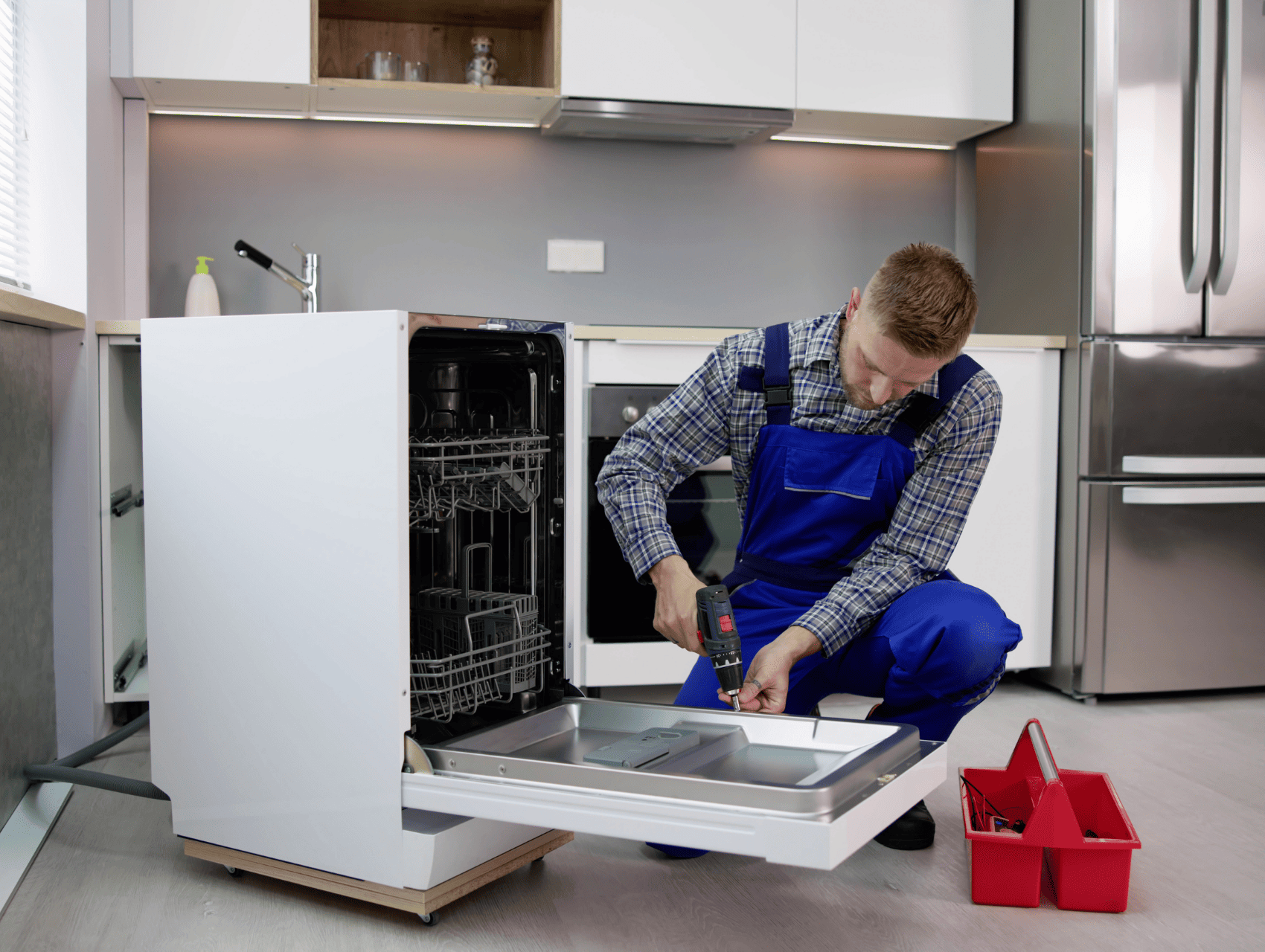 Appliance repair technician fixing a dishwasher
